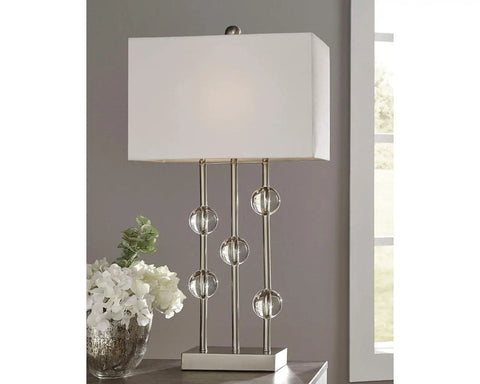 Jaala Modern Glam Metal And Crystal Table Lamp In Silver 31.75 Inch Tall With Crystal Accents next to white flowers on table