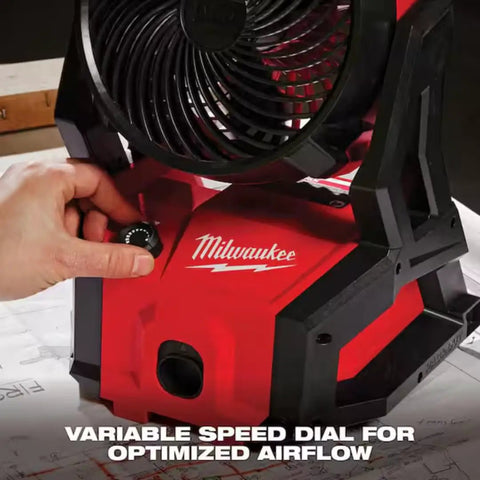 Person adjusting variable speed dial on 18V Brushless Packout Fan With Lightning Fast Cooling, Beastly 850 CFM, rugged red build