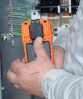 Person using Auto Ranging TRMS Digital Multimeter MM420 Pro Grade With 600V AC DC Voltage 10A Current near electrical panel