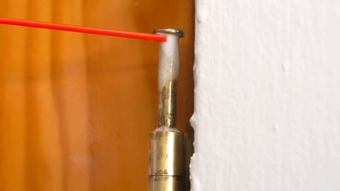 All-Around Multi-Use Lubricant Spray With Corrosion Protection applied to metal hinge, showcasing wet-style formula application