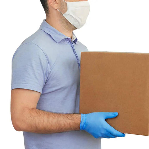 Top Notch Disposable Vinyl Exam Gloves In Steel Blue worn while carrying a cardboard box, providing hand protection.