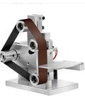 Mini Electric Belt Sander Desktop Grinder Badass Polisher And Edge Sharpener crushing dust with metal frame and sanding belt.