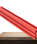 Built Tough Aluminum T Track Table Fence System With Laser Measure For Dead Accurate Miter Saw Cuts And Woodworking Projects On Portable Or Cabinet Saws on a wooden table, showcasing the red aluminum track.