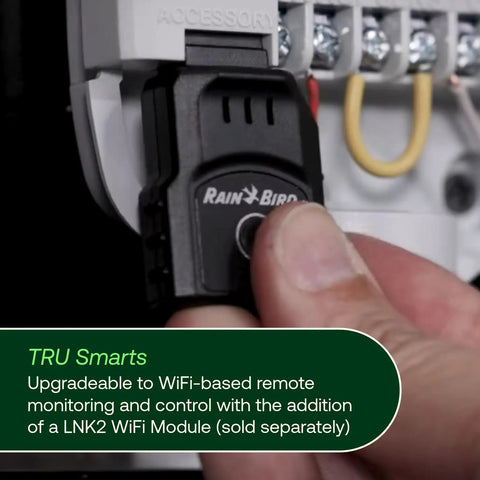 Hand inserting LNK2 WiFi module into program-based indoor irrigation controller for WiFi ready capability.