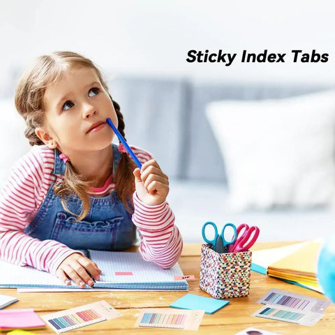 Child using Sticky Book Tabs Set With Repositionable Book Markers, colorful flags on a desk with notebook and scissors.