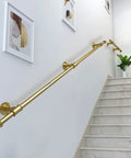 Heavy Duty Wrought Iron Stair Banister Handrail Featuring Top Shelf Metal Grab Bar For No Sweat Wall Mount Railing Safety Pro Grade Design For Seamless Indoor And Outdoor Living, gold finish, mounted on staircase wall.