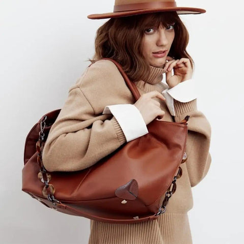 Woman carrying leather purse with DIY Bag Corner Repair Kit For Purses And Leather Bags With Corner Patches Cone Needle Thread