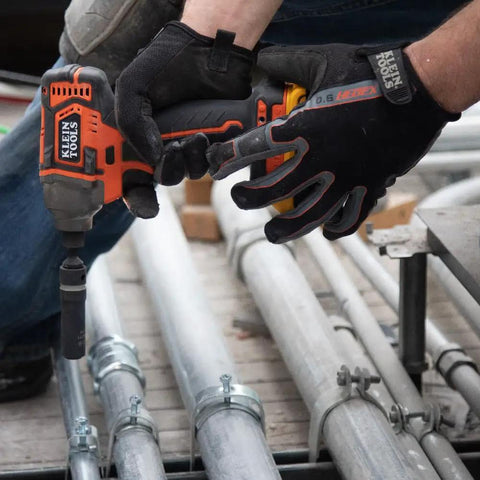 Worker using impact driver with Impact Socket Set For One Half Inch Drive Metric 12 Point Deep Sockets on metal conduit.