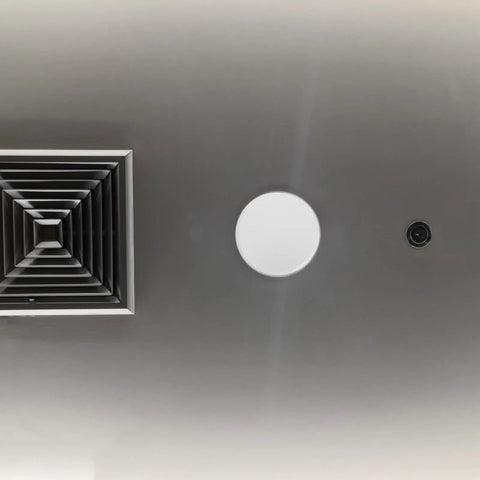 Slick Copper Fire Sprinkler Covers Decorative Escutcheon Caps installed on ceiling with ventilation grate and sprinkler head.