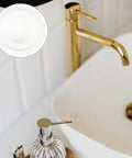 Close-up of 4 Pcs Silicone Bathtub Stopper White Flat Cover in bathroom sink with gold faucet.