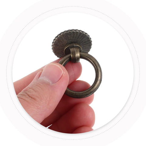 Close-up of hand holding Vintage Style Ring Pull Cabinet Handles 4 Pack Antique Bronze Drawer Pulls For Dresser Kitchen Cupboard Wardrobe Furniture Hardware With Single Hole Easy Install Durable Alloy Construction Old School Vibe