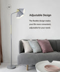 Dope Industrial Floor Lamp With Adjustable Metal Heads in a living room next to a grey sofa, showcasing its elegant design.
