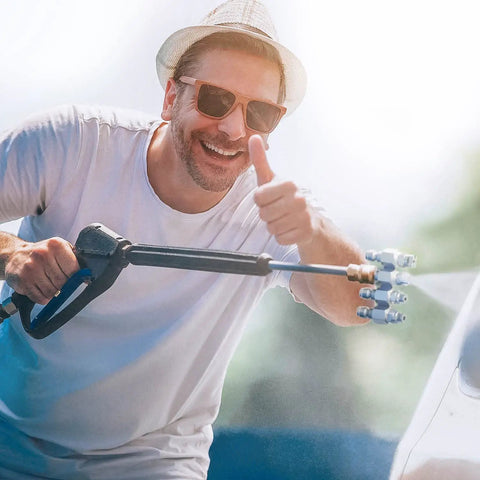Man using 4 GPM High Pressure Washer Nozzle Kit With 4 Way Nozzles And One Quarter Inch Quick Connect For Soft Wash System Stainless Steel Tips