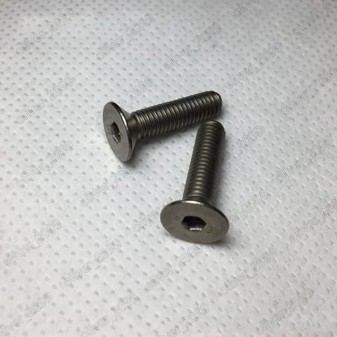 Top Shelf Titanium GR2 Hex Socket Flat Head Screws Metric Fine Thread Heavy Duty Aircraft Grade Fasteners M3 50Mm two screws on white background.