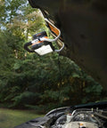 20V Power Share LED Work Light With 1500 Lumens hooked under car hood for repair, showing portability and shared battery system