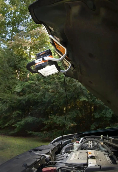 20V Power Share LED Work Light With 1500 Lumens hooked under car hood for repair, showing portability and shared battery system