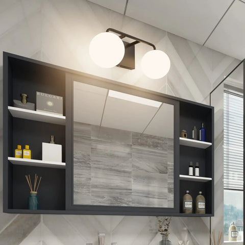 Two Light Mid Century Vanity Lights Over Mirror Matte Black With Milk White Glass Globes in bathroom setting