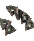 Close-up of five carbide turning inserts from the Ten Pack Of Premium Carbide Turning Inserts For CNC Metal Lathe Tool.