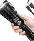 Hand holding Beast Bright Rechargeable Flashlight With 100,000 Lumens LED, showing LCD display, USB-C cable beside it.