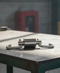 Heavy Duty Stainless Steel Swivel Rotation Joint Goes Like Butter For Dockside Hoists Workshop Rigs And Nautical Gear No Sweat Rust Proof Connector Fits Size Two Tubing on a worktable.