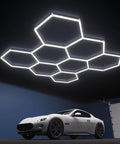 Eight Hexagon Garage Light With 350W 5000K Daylight LED, Modular Honeycomb Shop Light, installed in garage with car below.