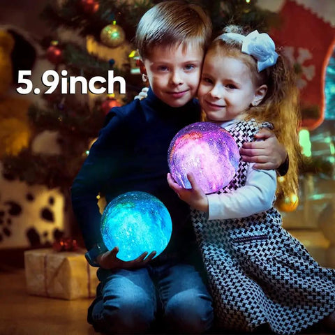 Moon Galaxy Lamp 5.9 Inch With 16 Color LED 3D Moon Light held by children near Christmas tree