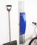 Heavy Duty Extendable Roof Snow Rake With Gliding Rubber Wheels And Lightweight Aluminum Handle, stored with a shovel.