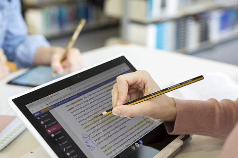 Hand using Plug And Play Digital Stylus Pen With Snug Hex Grip For Silky Smooth Writing On All Touchscreens with laptop.