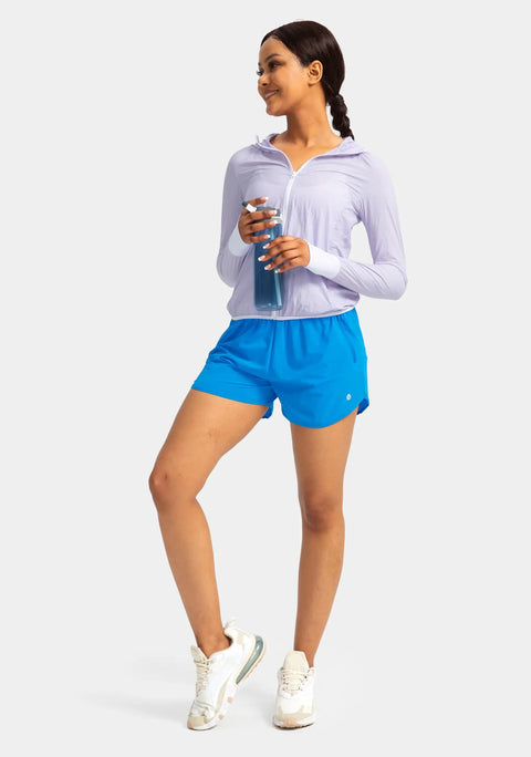 Woman wearing blue quick-dry running shorts, holding a water bottle, showcasing Womens Quick-Dry Running Shorts With Zipper Pockets And Built-In Liner, Run Ready, Lightweight Breathable Athletic Gym Short, 3 Inch Inseam, Dark Gray, Size Medium, Sweat-Wicking, Phone Safe For Runs.