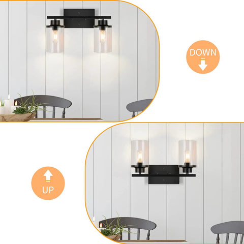 Matte Black Two Light Vanity Light Fixtures With Clear Glass Shades Over Mirror Wall Sconces in bathroom showing up and down positions