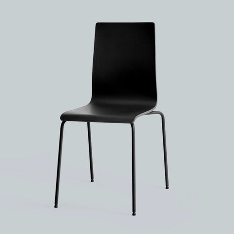 Black molded plastic dining chair with curved back and slim metal legs.