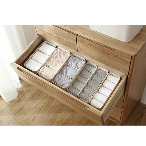 Four Piece Plastic Drawer Organizer Box With Compartment Dividers For Bras Underwear And Socks, grey bins neatly organizing clothing.