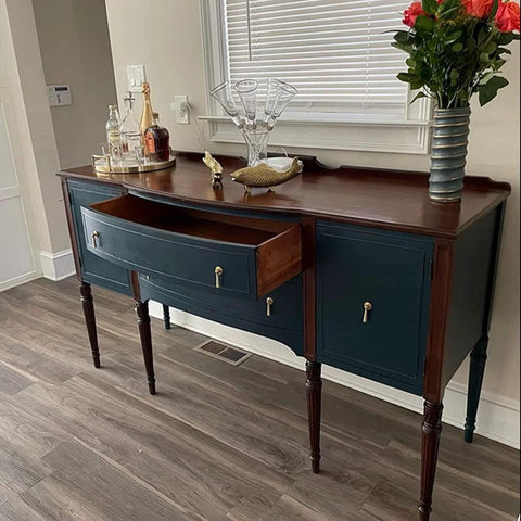 Antique sideboard with open drawer, decorated with glassware and flowers, featuring Two Pieces Brass Tear Drop Cabinet Knob Pulls in antique style.
