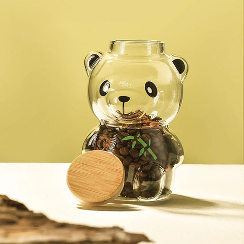Airtight Glass Coffee Bean Jar With Fun Panda Lid showing coffee beans inside, bamboo lid beside on light background.
