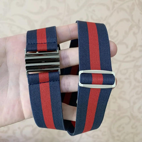 Hand holding a striped blue and red belt with shiny metal buckle and adjuster. Interlocking Metal Belt Buckles Set Of 15 For DIY Belts and Leather Straps Rectangle Quick Release Clips In Black Gold Silver Adjustable Fasteners For Women And Men not visible.