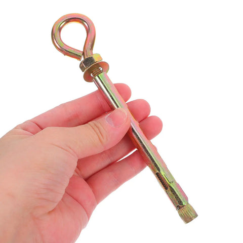 Hand holding one piece from 10 Pack Heavy Duty Carbon Steel Eye Bolts With Expansion Anchors For Outdoor Swings And Hammock Hanging Kit