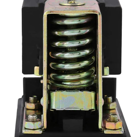 Close-up of air compressor pressure switch spring and housing, highlighting durability and precise PSI control features.