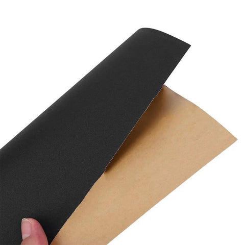 Top Tier 100 Piece Sandpaper Sheets For Woodworking Pros, showing a black aluminum oxide sheet ready for sanding.