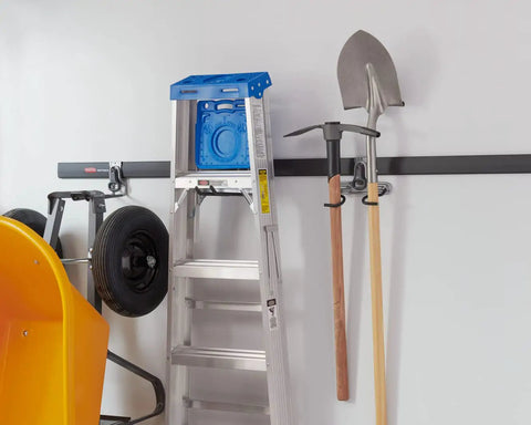 FastTrack Ladder Hook Wall Mount System with tools, ladder, and handles organized in a garage on a steel rail.
