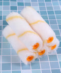 4 mini paint roller covers in white with yellow stripes, suitable for drywall, mud, and concrete surfaces in 20-Piece Mini Paint Roller Covers Kit.
