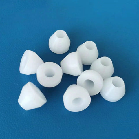 10 white nonstick bushings, part of 20 Pack Insulating Pen Bushings For Woodturning, 0.43 inch diameter on blue background