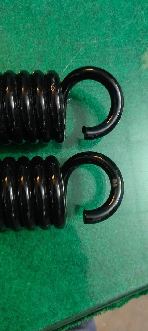 Pro Grade Heavy Duty Extension Springs Eleven Inch Hook To Hook By 1.94 Inch Outside Diameter close-up of black silicone steel springs.