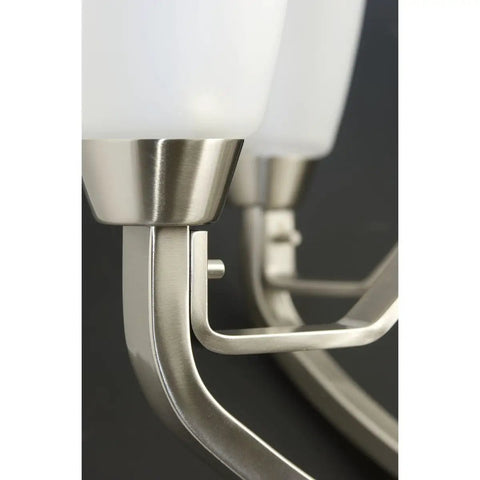 Close-up of bracket on Three Light Sleek Modern Bath Vanity Light With Etched Glass In Brushed Nickel Transitional Style Dimmable