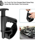 Nylon Tire Bead Clamp Drop Center Tool for Cars, heavy duty rim pry, close-up of hands using black nylon tool on tire.