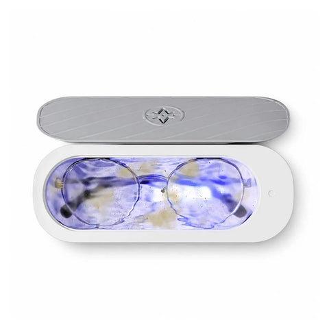 Portable Ultrasonic Jewelry Cleaner For Rings Silver Watches Retainers And Glasses Compact Countertop Machine on white background with glasses inside.