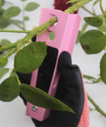 Gloved hand using Rose Thorn Stripper Tool Kit For Garden Pruning Shears And Scissors With Gloves Includes Plastic Rose Thorn Remover