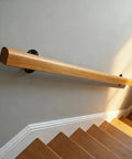Heavy Duty Solid Pine Handrail Knockout Non Slip Staircase Grab Bar Wall Mounted Safety Railing For Home Garden And Loft Easy Install Smooth Finish Perfect For Kids And Seniors Two Foot Model Built Tough mounted on wall beside staircase.
