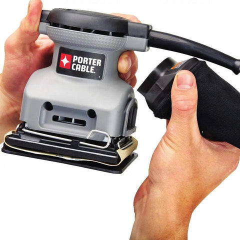 Person holding Palm Sander 1 Quarter Sheet 380 with 2.0 Amp Motor, lightweight design, showing dust bag attachment.