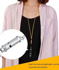 Person wearing stainless steel ultrasonic pigeon whistle with lanyard for bird training and pet behavior improvement.