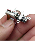 Close-up of High Precision 5mm Gearbox Stepper Motor With 8mm Stroke Linear Actuator held in hand, showing metal design and compact size.
